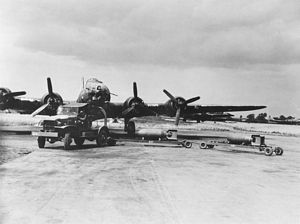 Jeep towing two bombs up to B-17